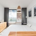 Small apartment bedroom with space-saving furniture, smart storage, and modern decor