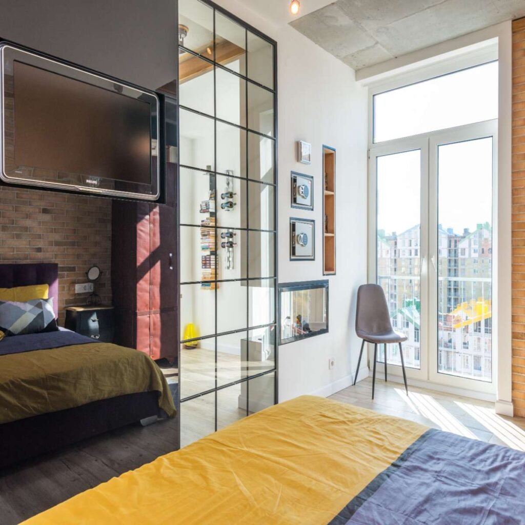 Bright small apartment bedroom decorated with light neutral colors, soft bedding, and simple modern furniture