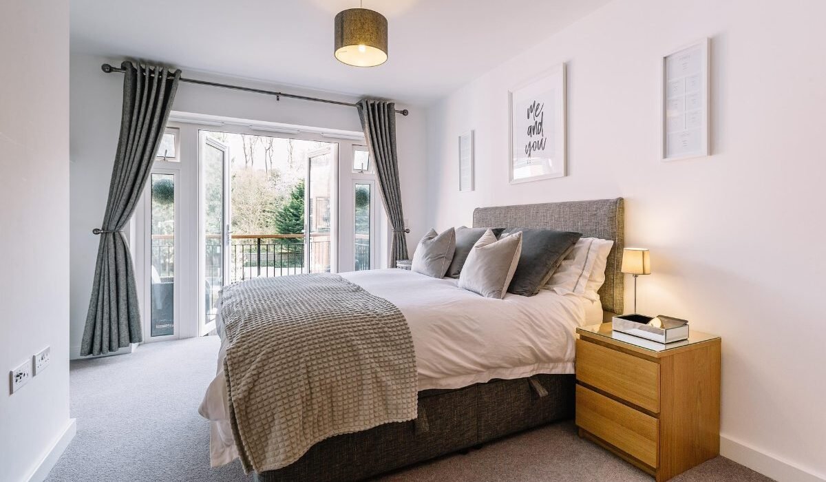 Modern bedroom decor ideas on a budget featuring a bright and cozy bedroom with neutral bedding and natural light