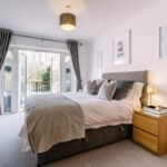 Modern bedroom decor ideas on a budget featuring a bright and cozy bedroom with neutral bedding and natural light