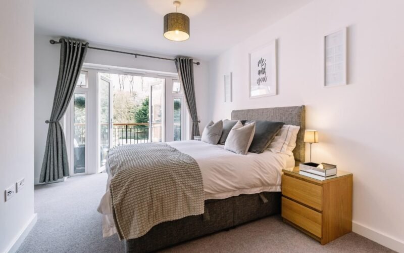 Modern bedroom decor ideas on a budget featuring a bright and cozy bedroom with neutral bedding and natural light