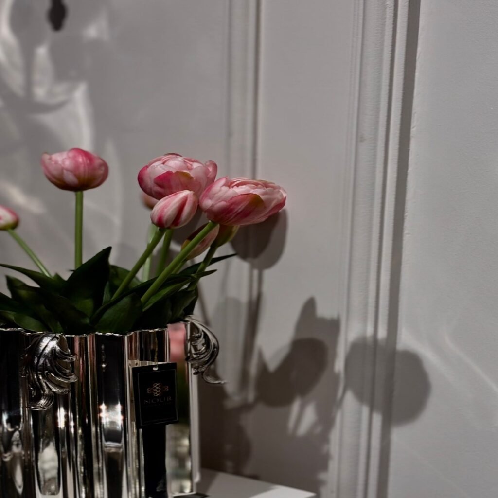 Chrome vase with greenery on a modern coffee table