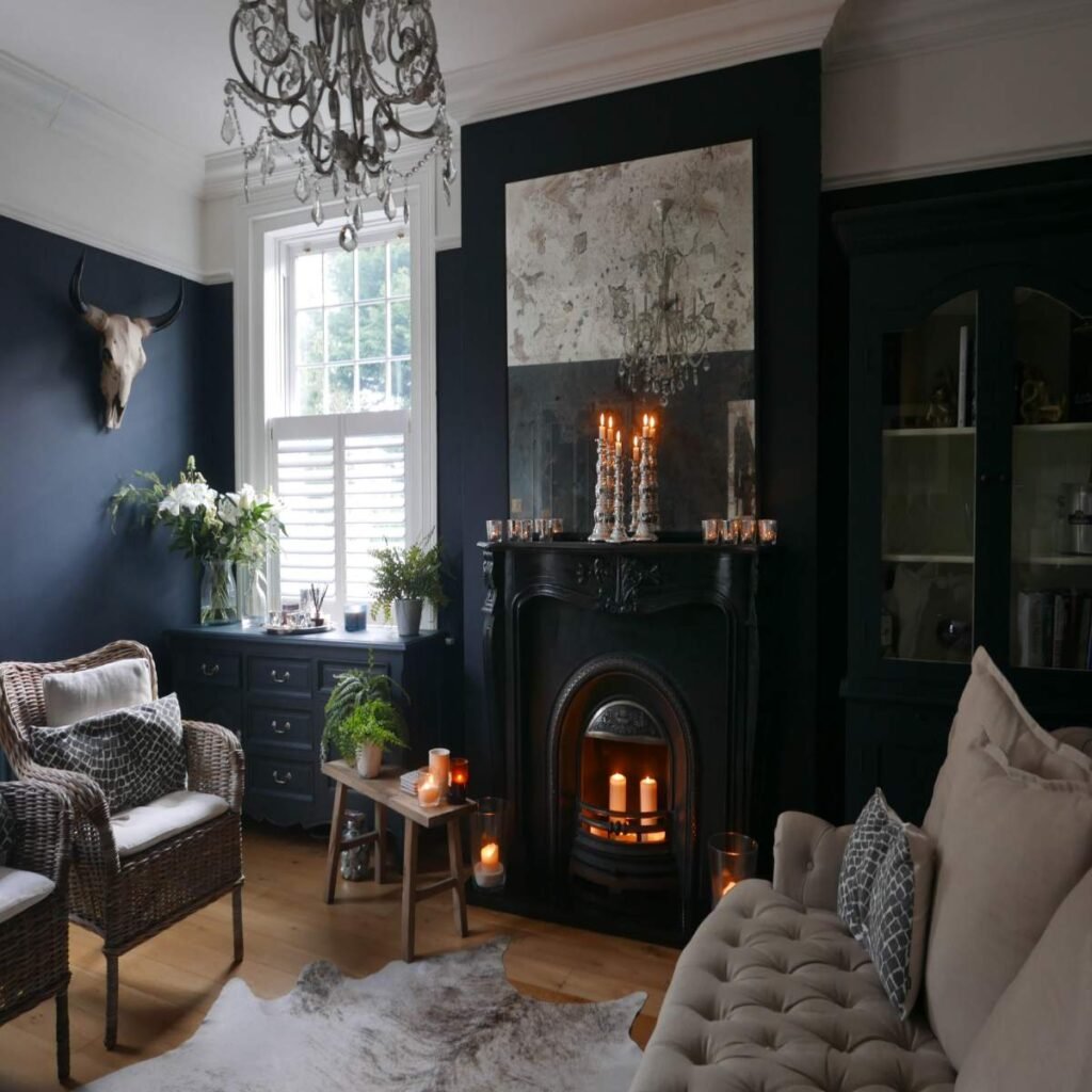 Dark boho living room with a deep accent wall, warm neutral sofa, and natural wood decor