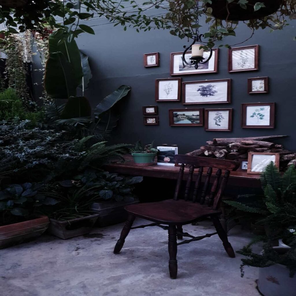 Dark boho living room with a gallery wall, mixed frames, botanical prints, and vintage artwork