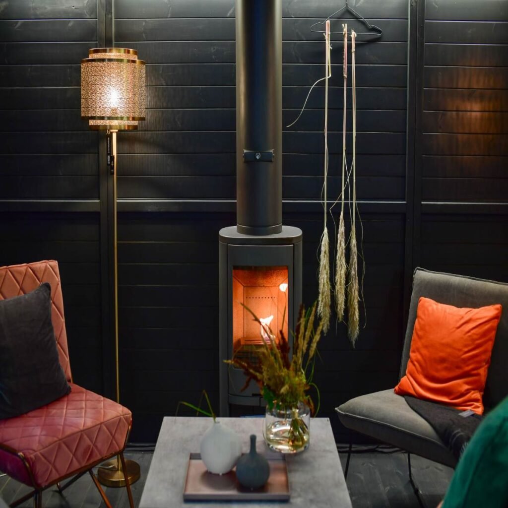 Dark boho living room with warm lighting, a floor lamp, and cozy earthy decor
